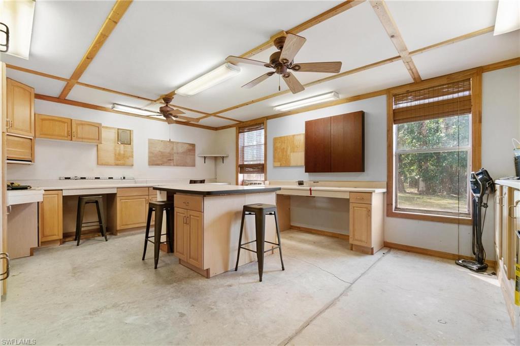 1041 29th Street Southwest Naples, FL 34117 - Photo 48 of 50 a living room with stainless steel appliances kitchen island granite countertop furniture and a flat screen tv