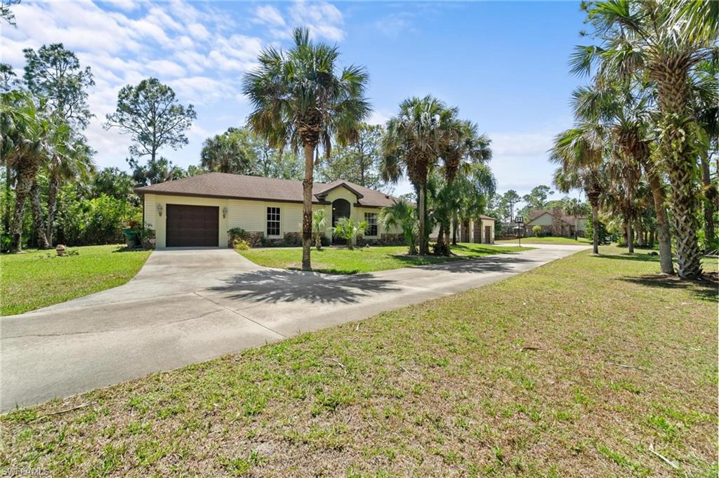1041 29th Street Southwest Naples, FL 34117 - Photo 6 of 50 a view of house with outdoor space and trees