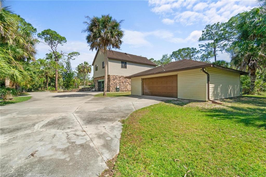 1041 29th Street Southwest Naples, FL 34117 - Photo 8 of 50 a front view of house with yard and trees
