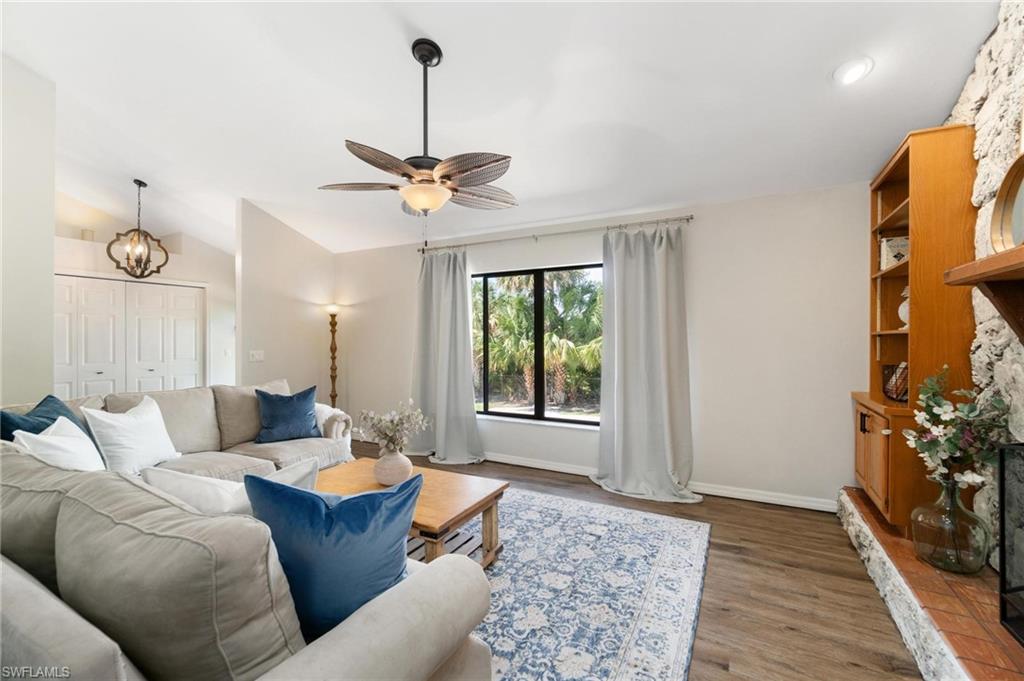1041 29th Street Southwest Naples, FL 34117 - Photo 10 of 50 a living room with furniture a chandelier and a window