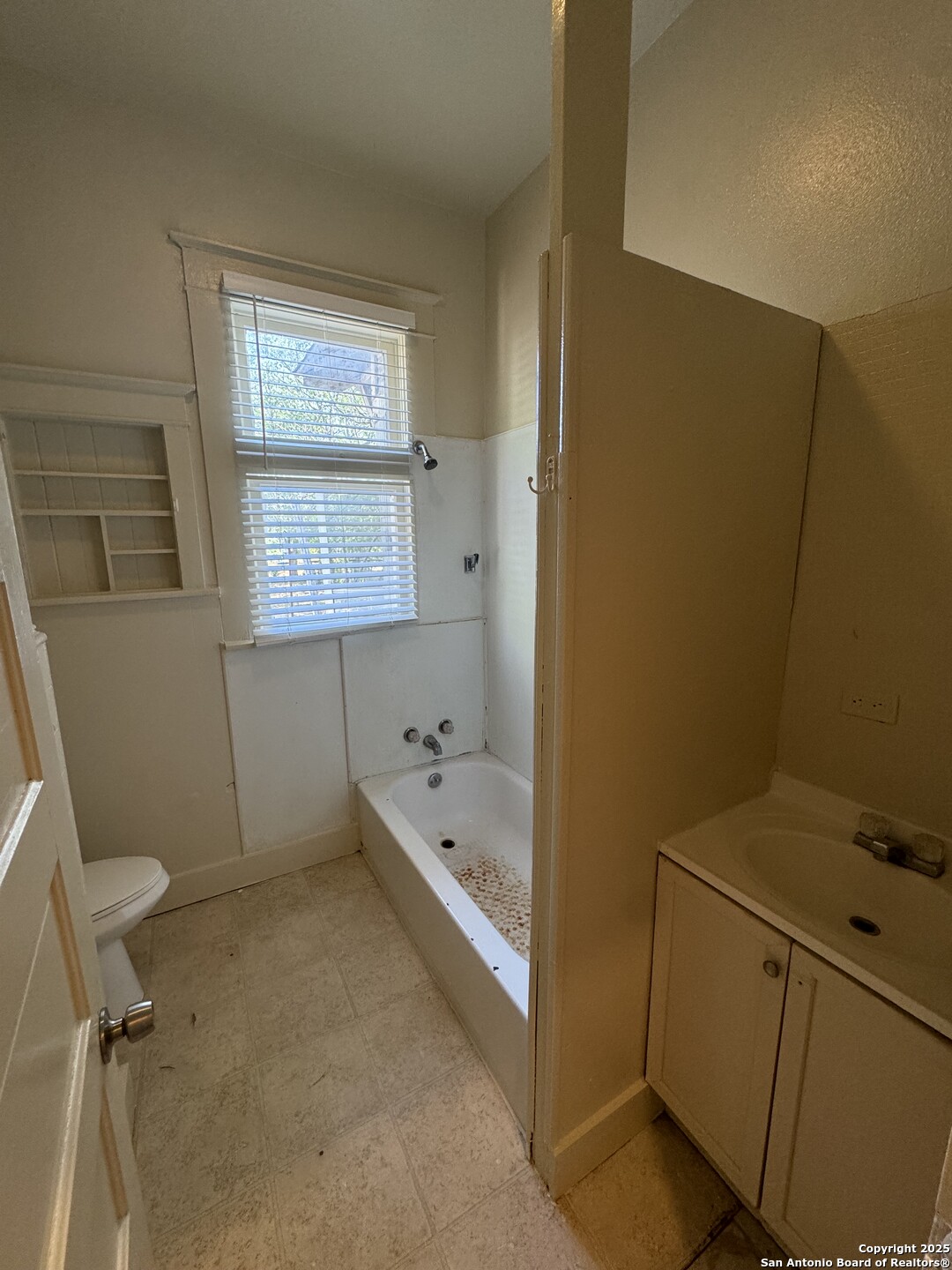 262 Orchard Road San Antonio, TX 78220 - Photo 11 of 16 a bathroom with a tub toilet and a sink