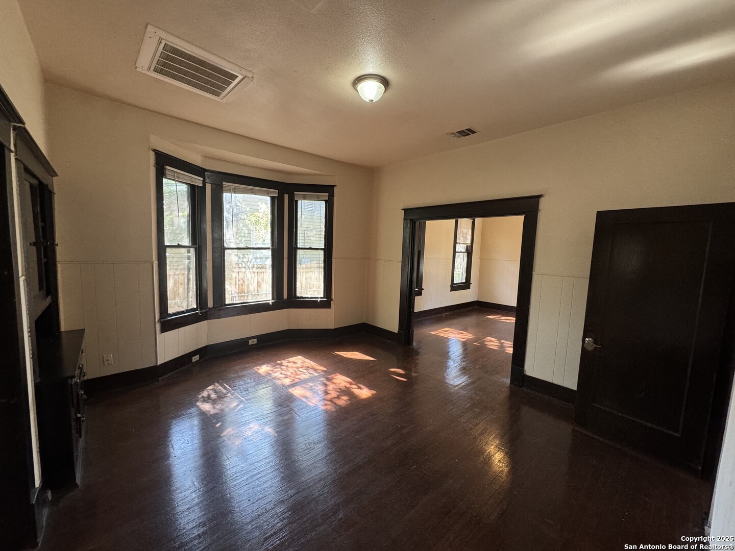 262 Orchard Road San Antonio, TX 78220 - Photo 7 of 16 a view of an empty room with wooden floor and a window