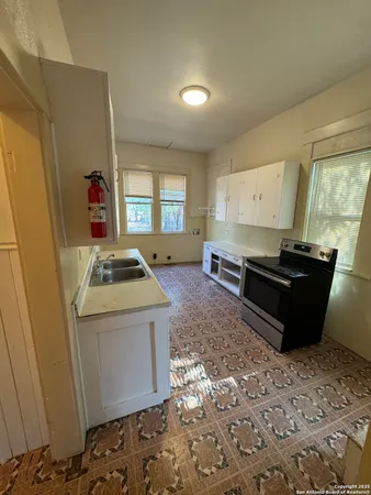 a kitchen with sink stove and refrigerator