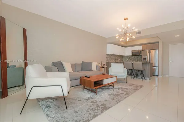 a kitchen with stainless steel appliances a refrigerator sink and microwave