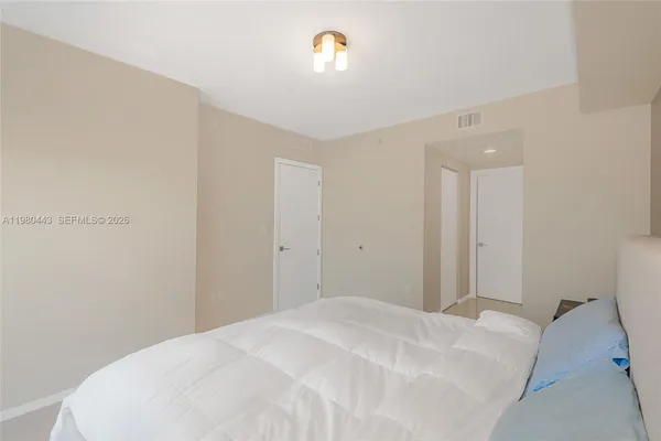 a living room with furniture and large windows