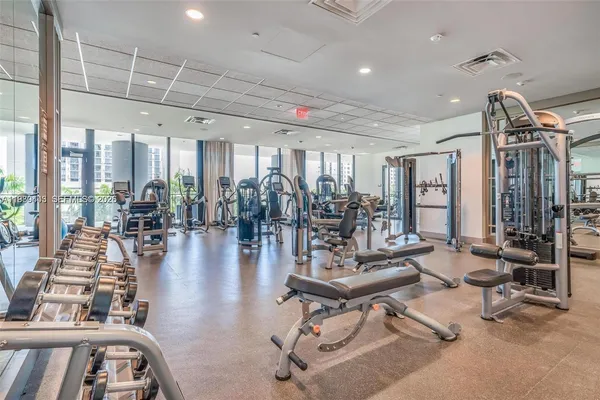 a view of a dining room with furniture a chandelier and wooden floor