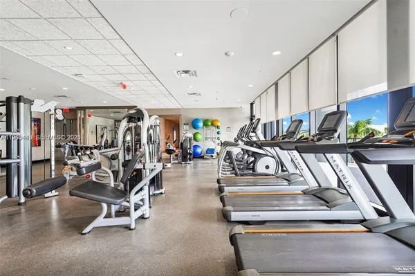a living room with fireplace furniture and a large window