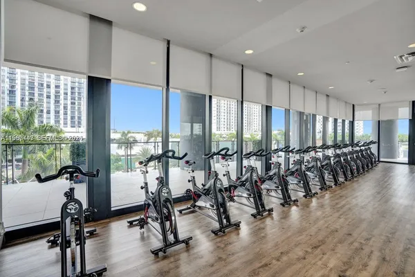 a view of a patio with table and chairs potted plants and palm trees