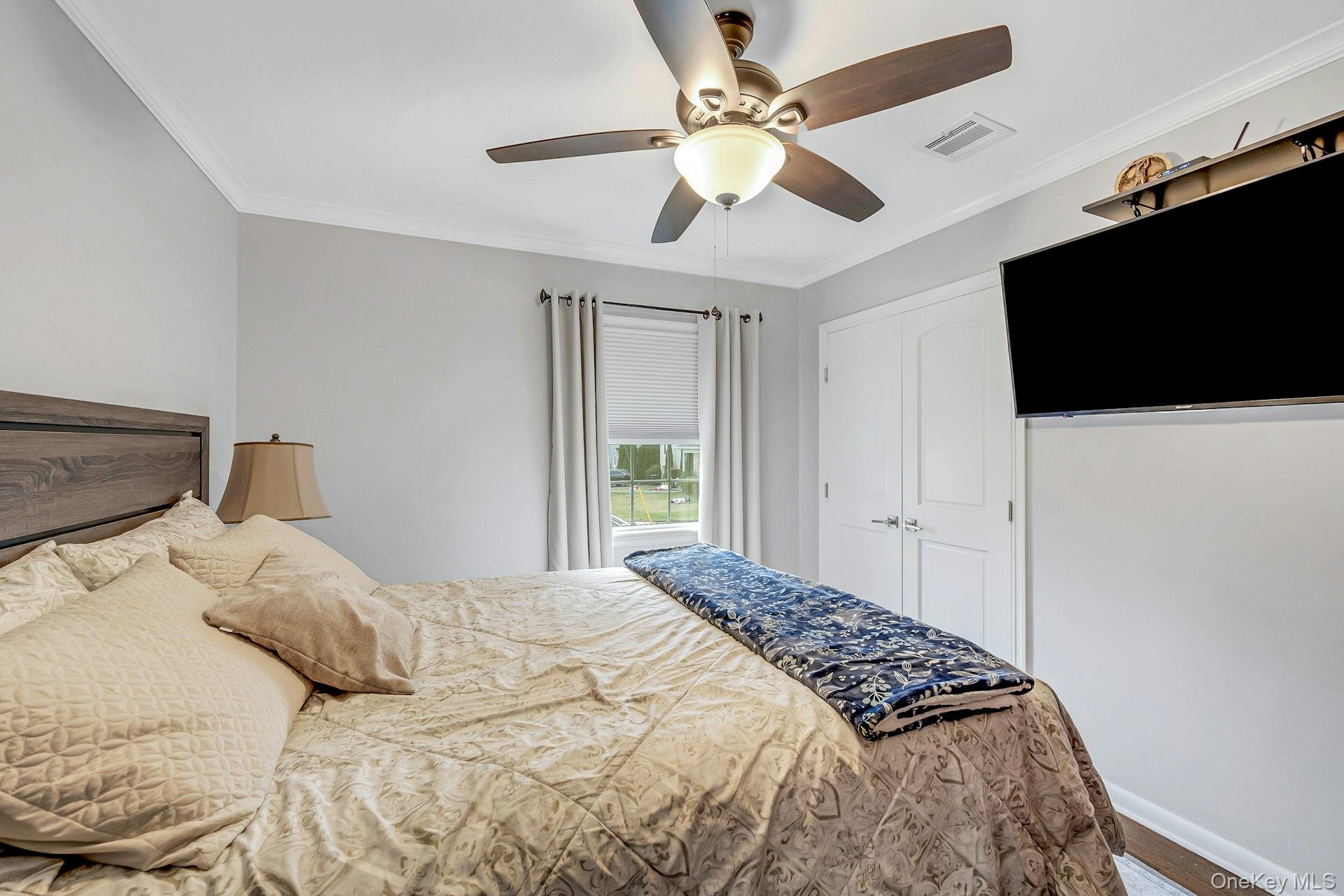 155 Hilburn Road Scarsdale, NY 10583 - Photo 16 of 35 a bedroom with a large bed and a flat screen tv