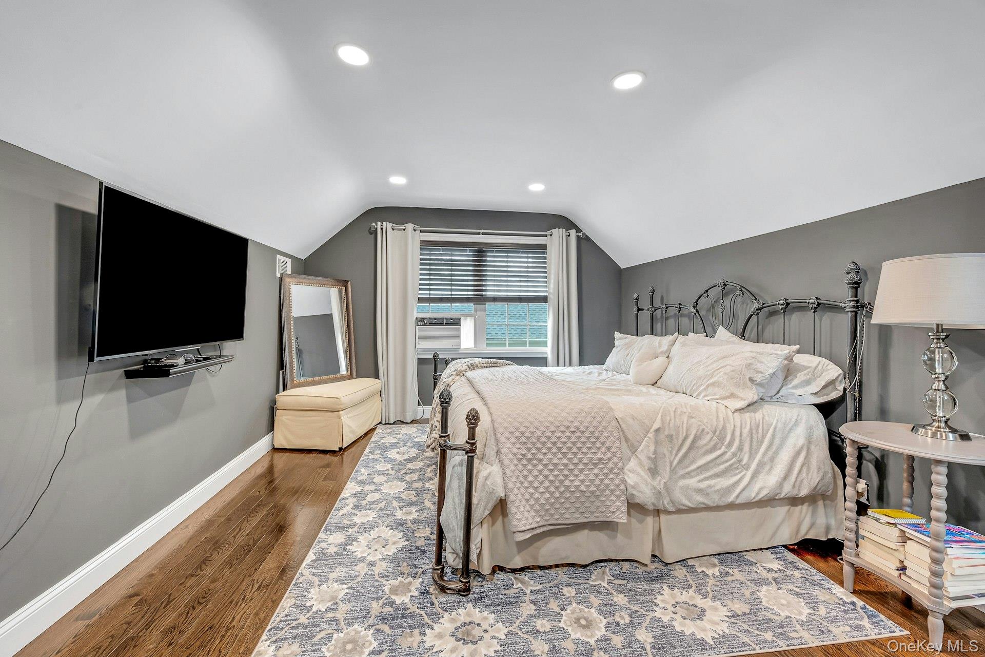 155 Hilburn Road Scarsdale, NY 10583 - Photo 18 of 35 a bedroom with a bed and a flat screen tv