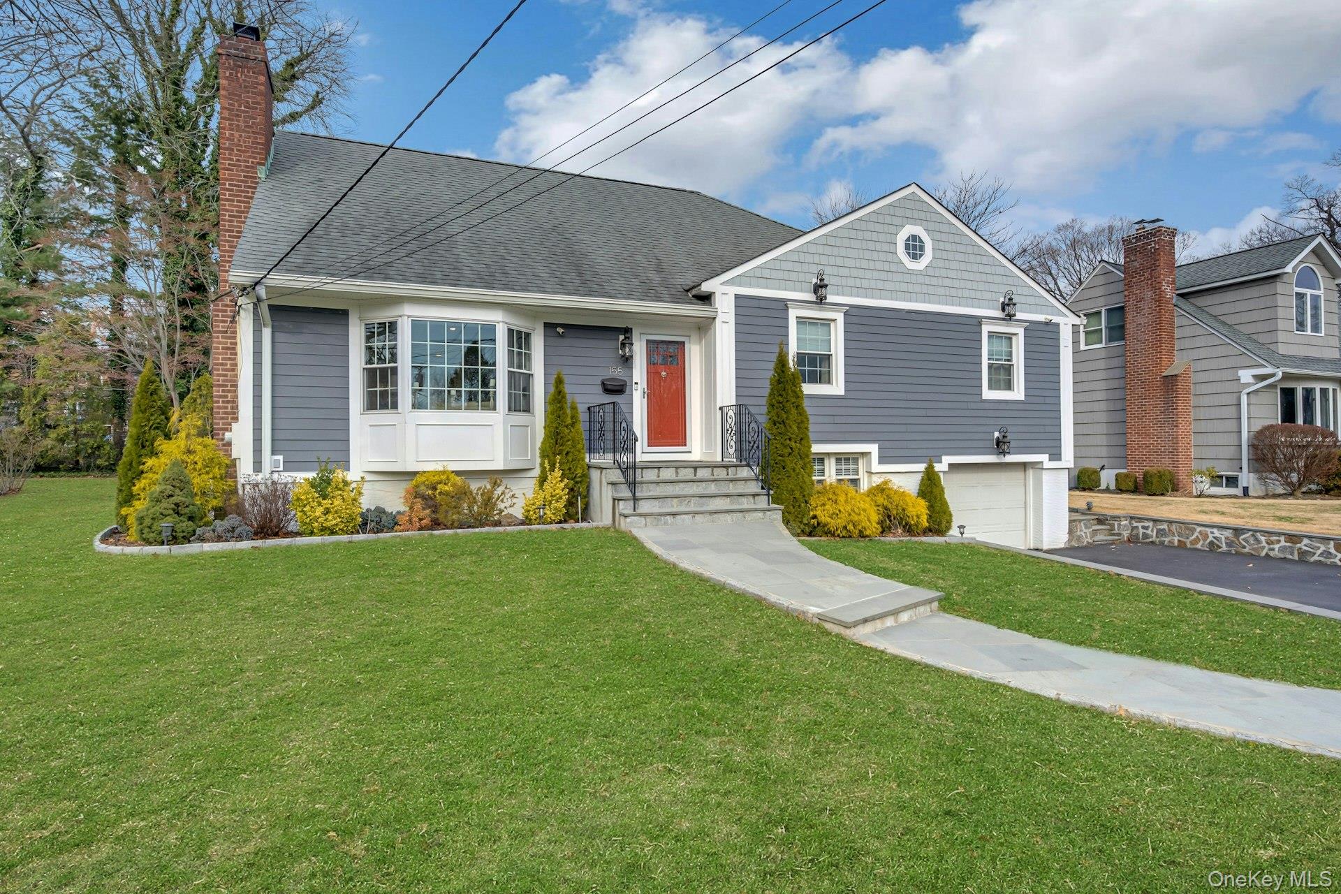 155 Hilburn Road Scarsdale, NY 10583 - Photo 2 of 35 a front view of a house with a yard