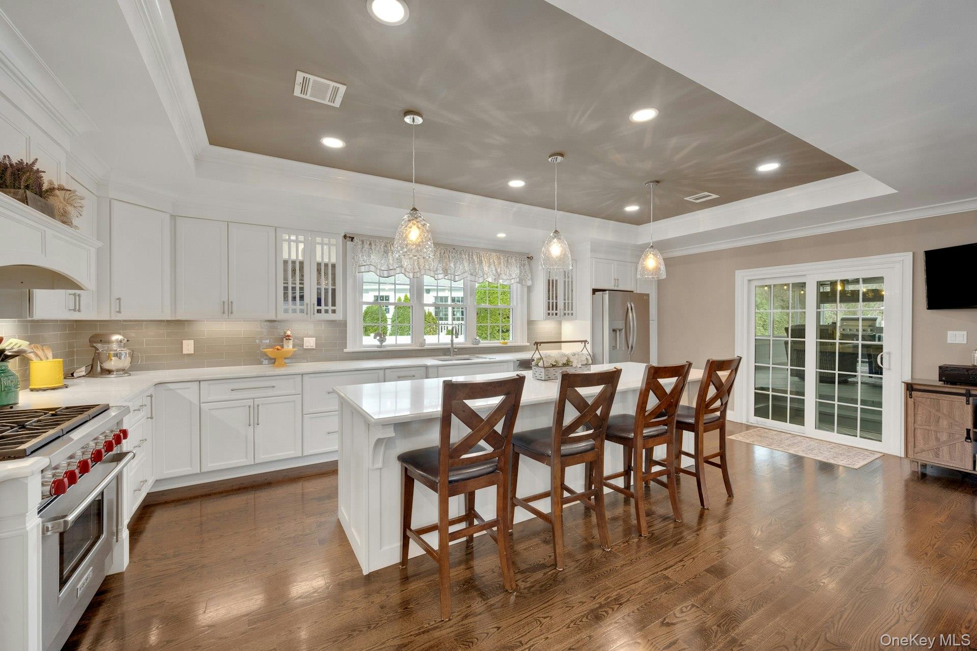 155 Hilburn Road Scarsdale, NY 10583 - Photo 5 of 35 a kitchen with white cabinets and wooden floor