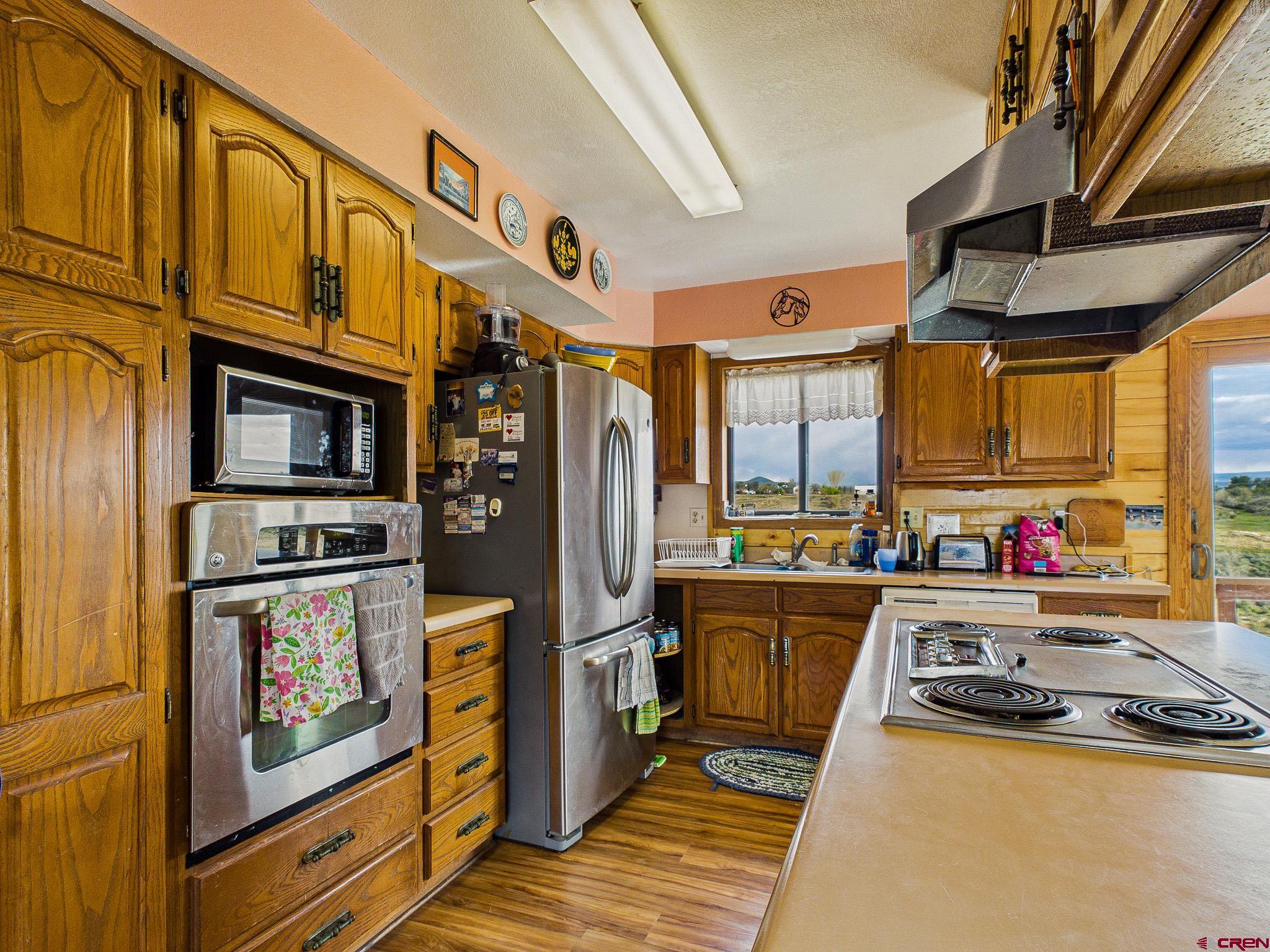 37760 Back River Road Paonia, CO 81428 - Photo 20 of 38 a kitchen with stainless steel appliances granite countertop a stove and a refrigerator
