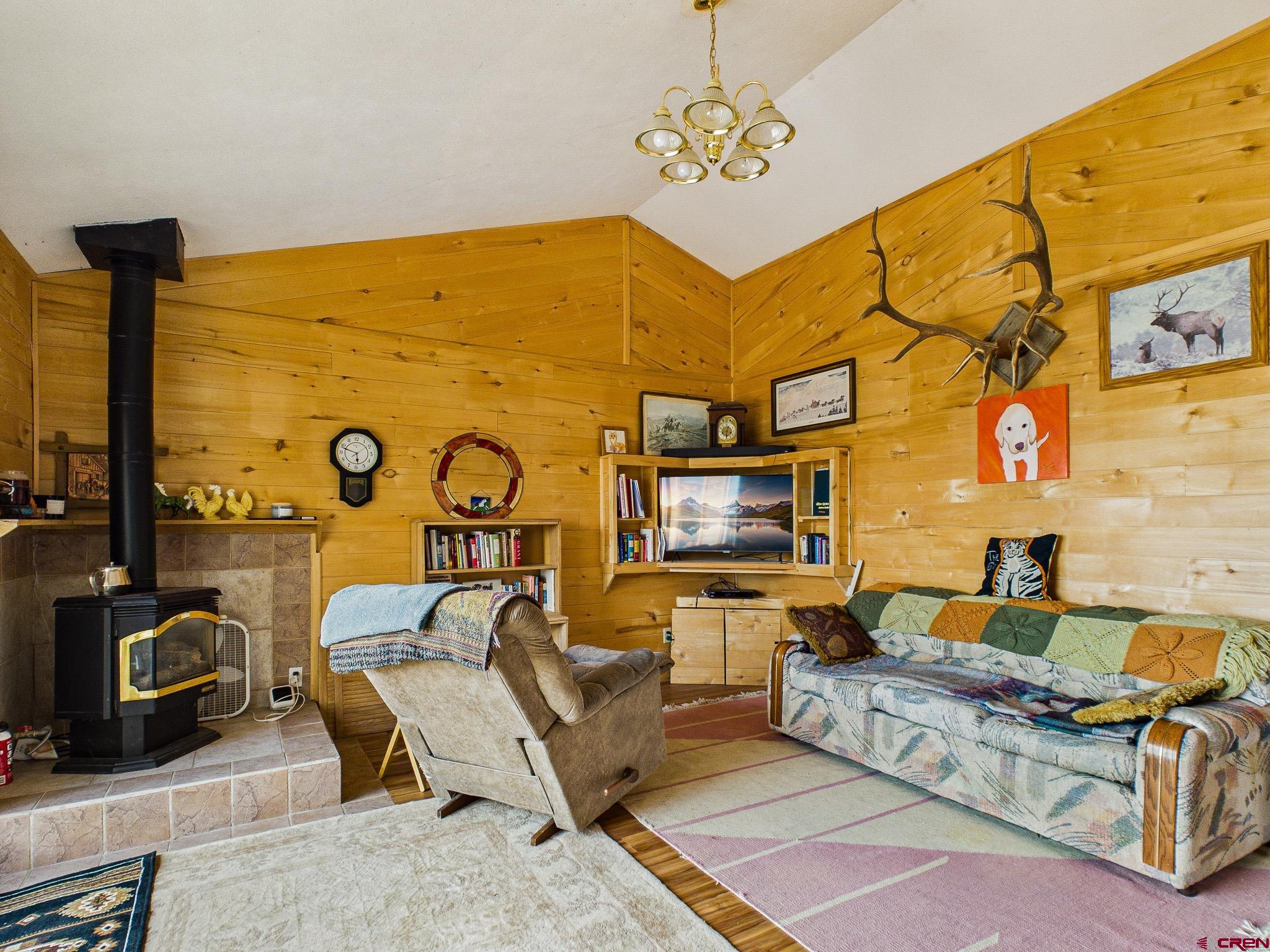 37760 Back River Road Paonia, CO 81428 - Photo 21 of 38 a living room with fireplace furniture and a flat screen tv