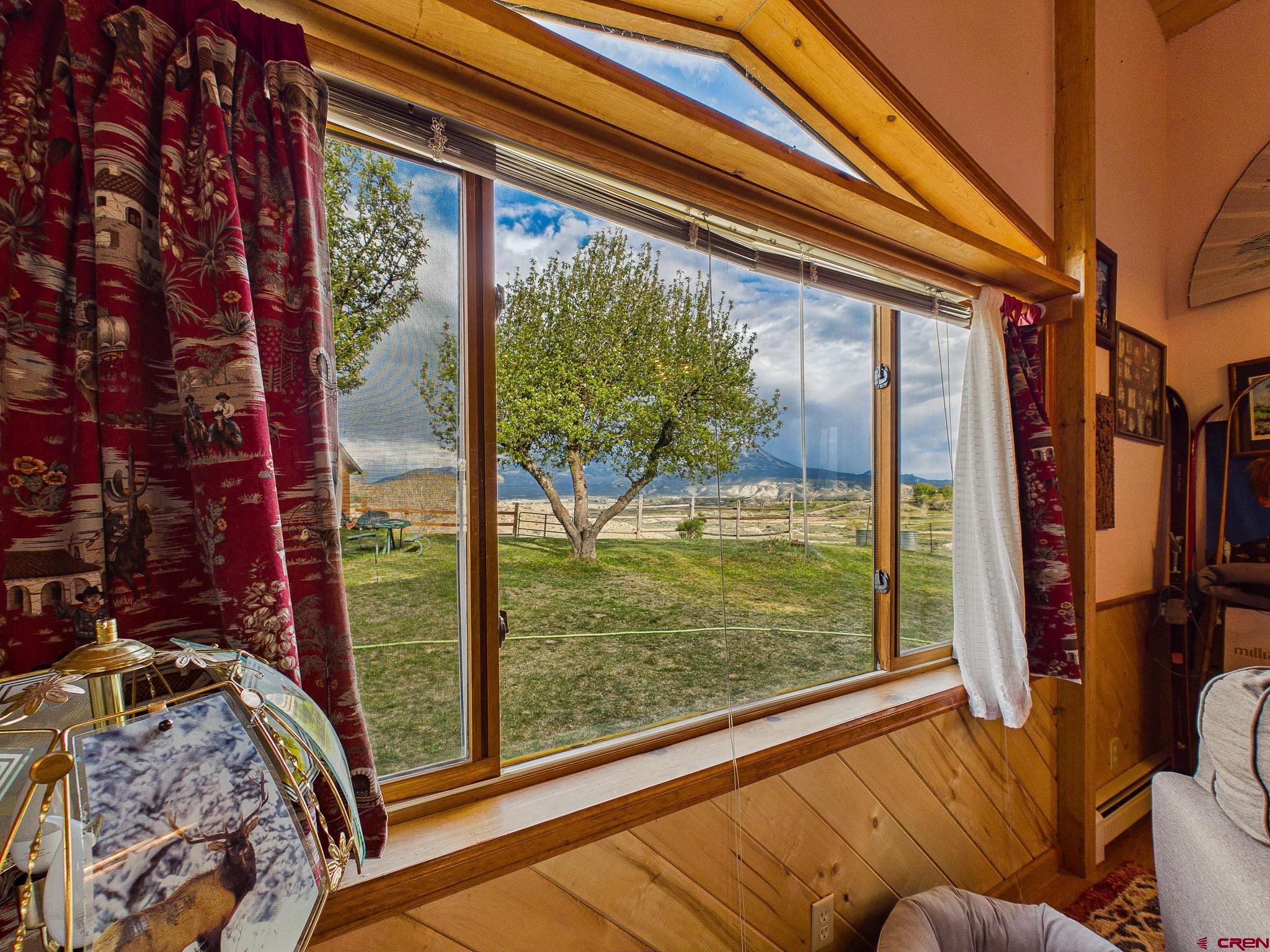 37760 Back River Road Paonia, CO 81428 - Photo 29 of 38 a bedroom with a bed and a large window with garden view