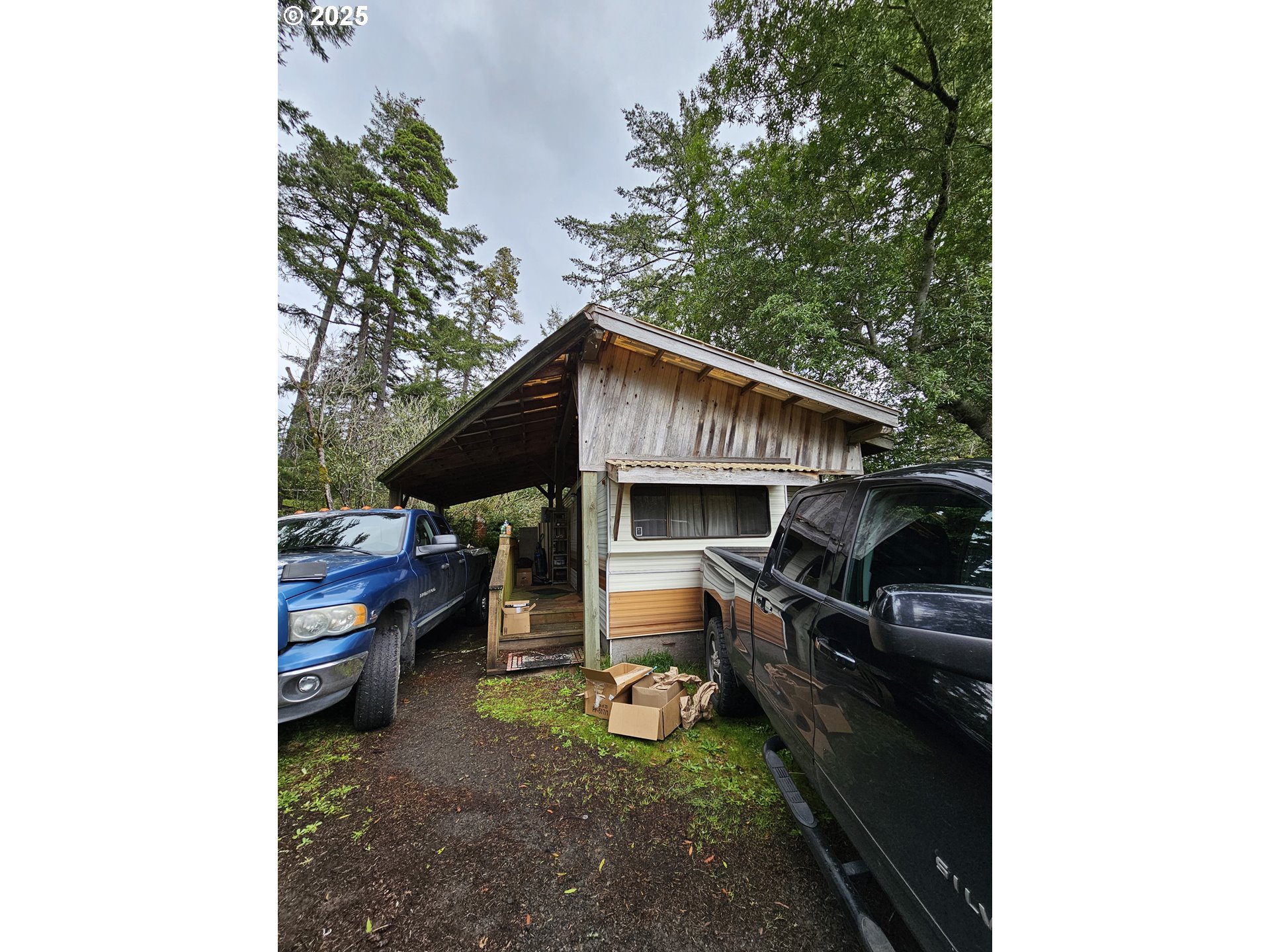 223 Azalea Street Florence, OR 97439 - Photo 2 of 2 a backyard of a house with barbeque oven and outdoor seating