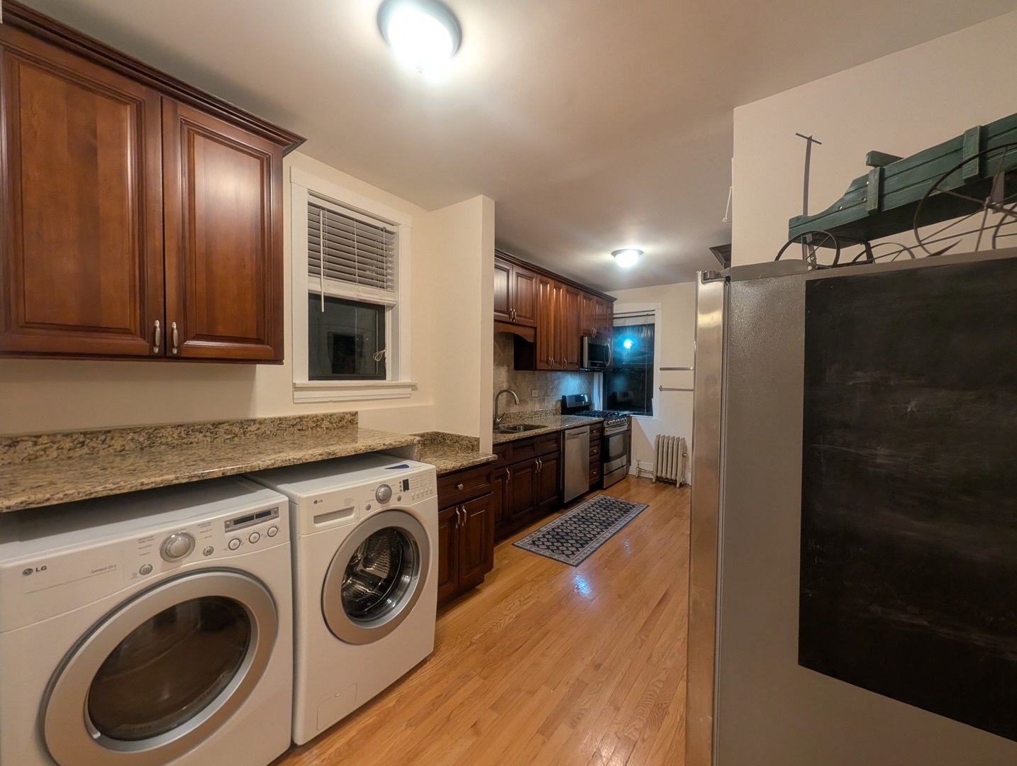 1419 East 56th Street, Unit 1 Chicago, IL 60637 - Photo 13 of 35 a view of a kitchen with stainless steel appliances granite countertop a refrigerator and a sink