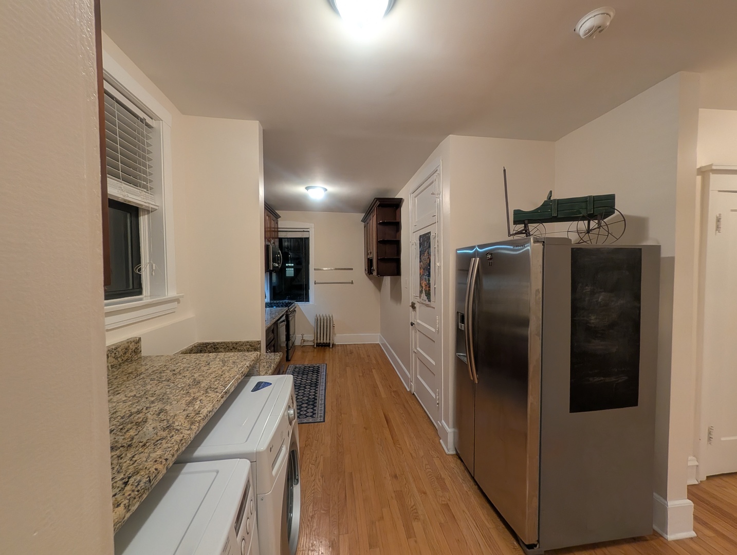 1419 East 56th Street, Unit 1 Chicago, IL 60637 - Photo 14 of 35 a kitchen with stainless steel appliances granite countertop a refrigerator and a sink