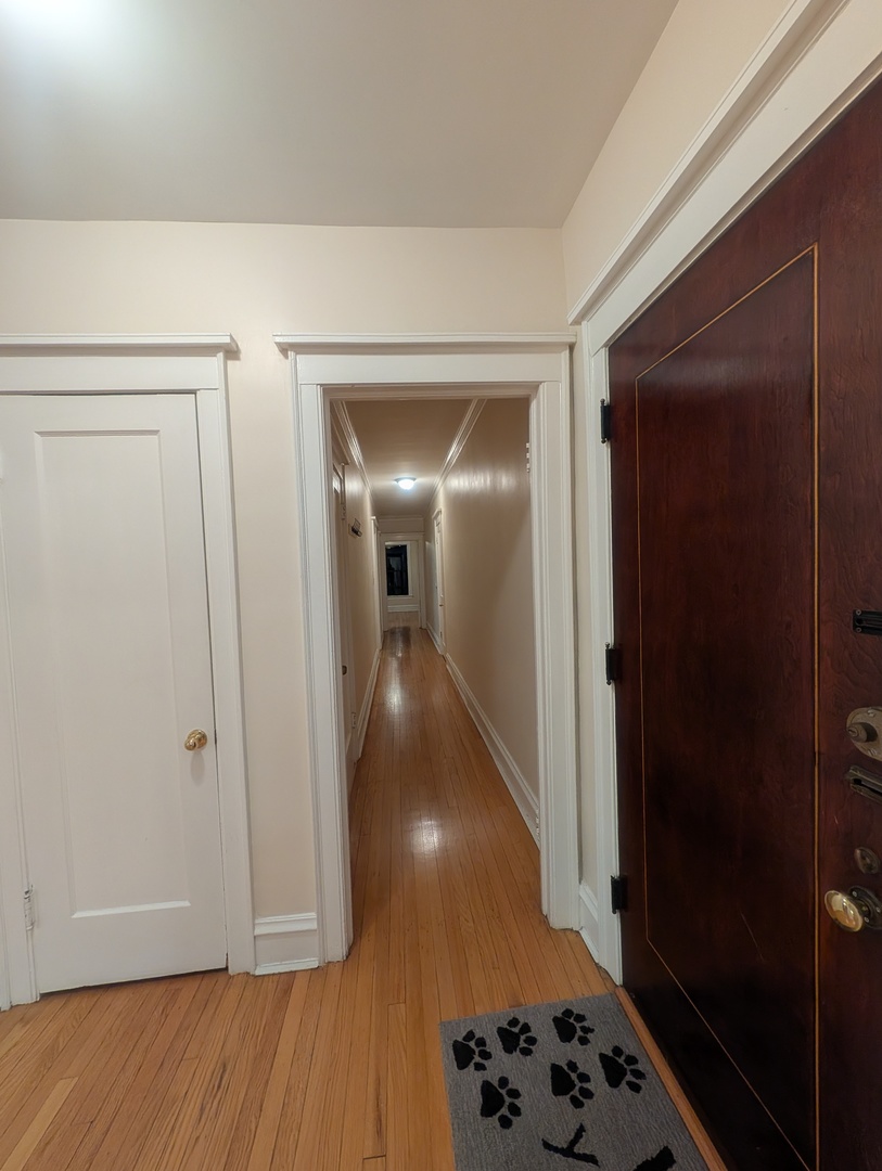 1419 East 56th Street, Unit 1 Chicago, IL 60637 - Photo 15 of 35 a view of a hallway with wooden floor