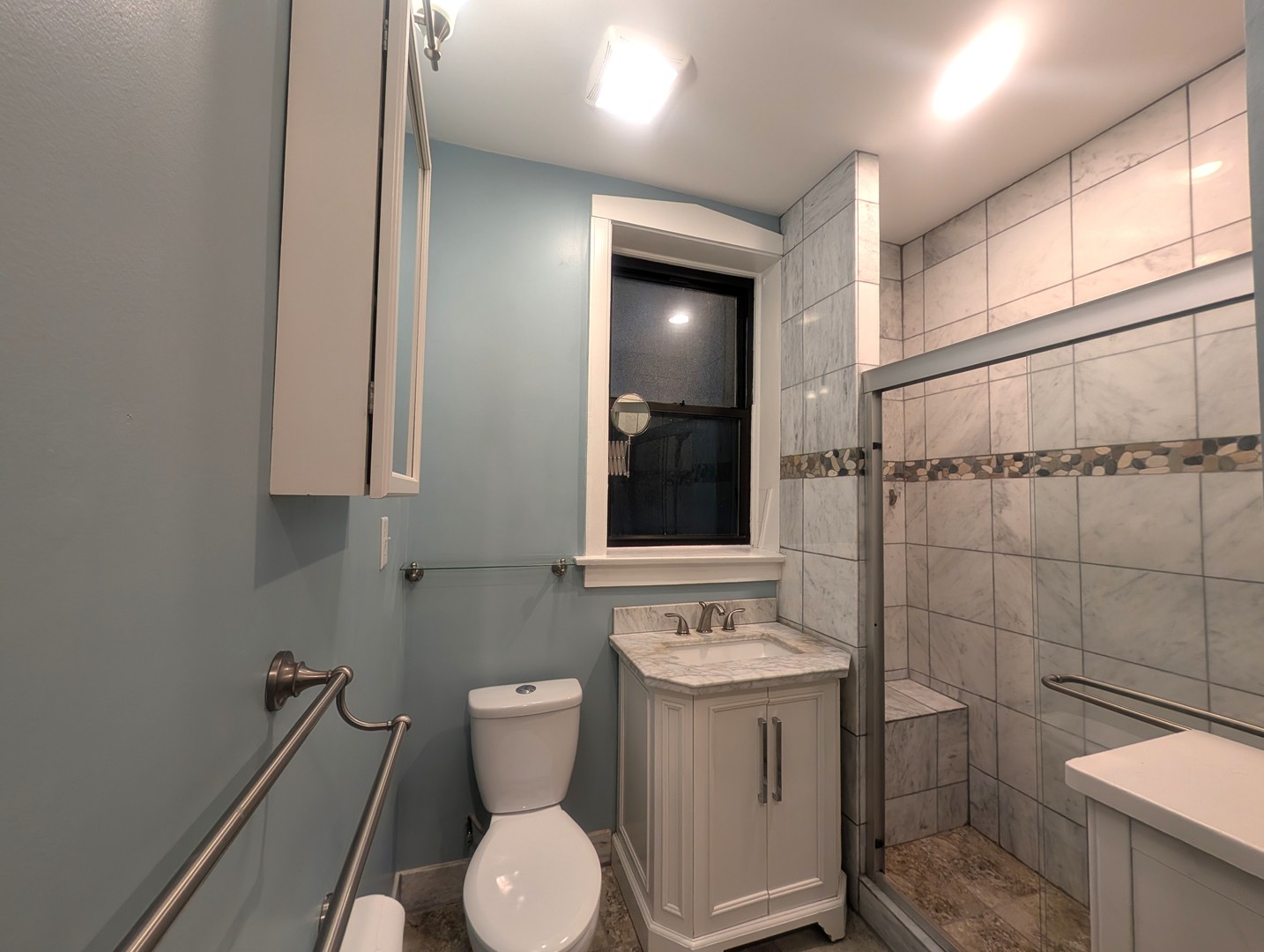 1419 East 56th Street, Unit 1 Chicago, IL 60637 - Photo 19 of 35 a bathroom with a toilet sink and mirror