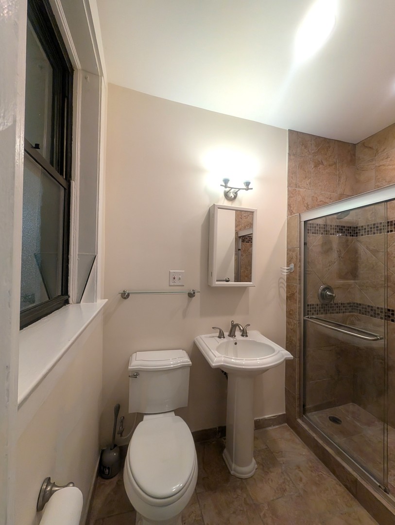 1419 East 56th Street, Unit 1 Chicago, IL 60637 - Photo 23 of 35 a bathroom with a toilet sink and shower