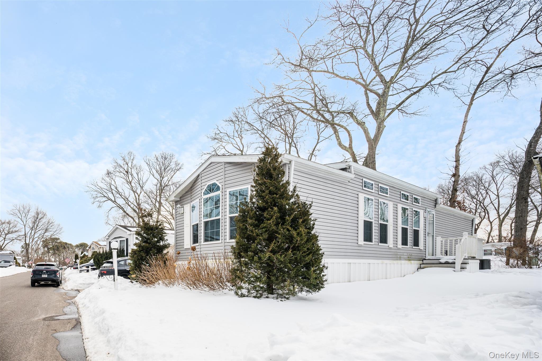 a view of a white house with a snow on the road