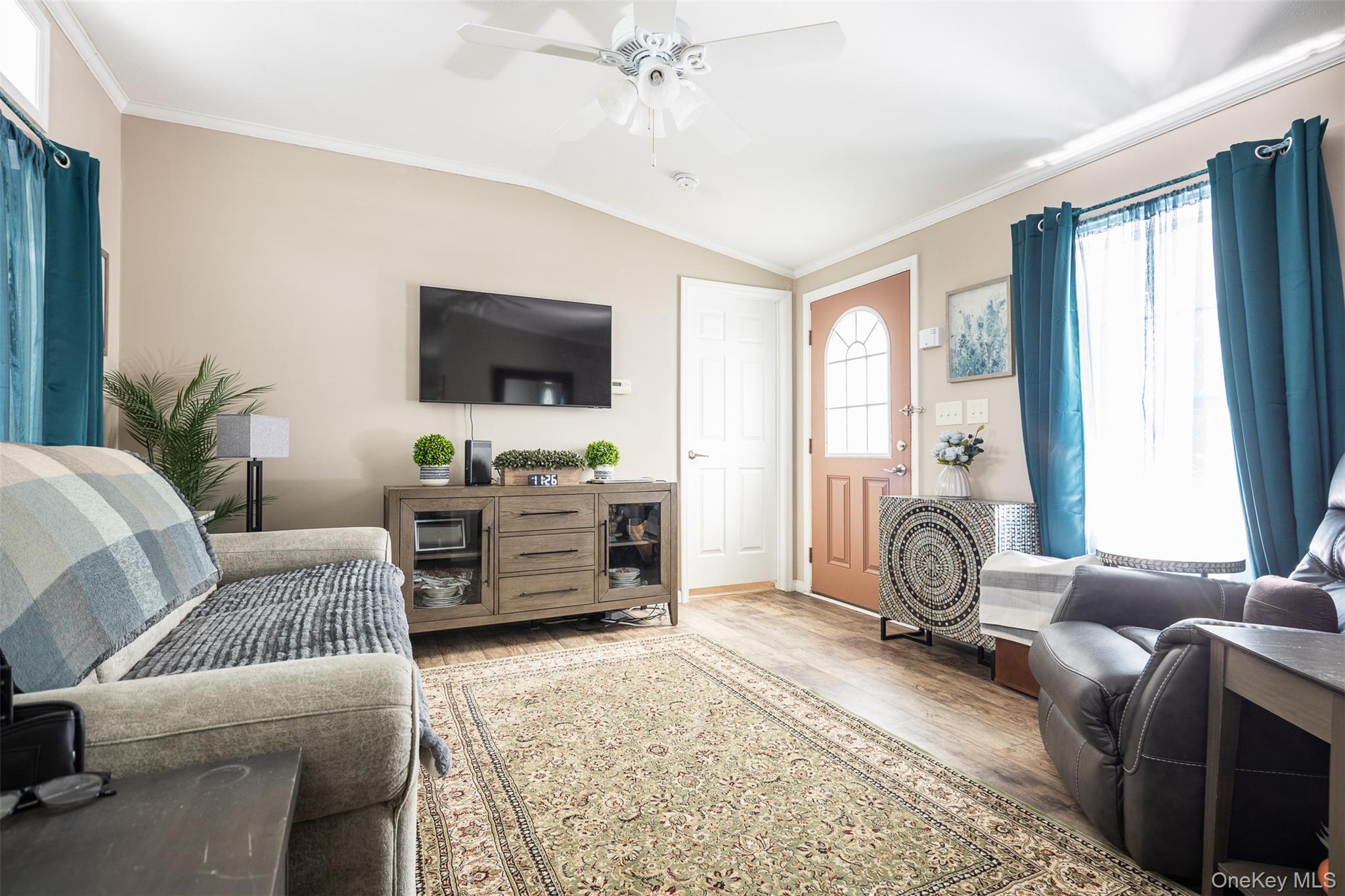 1661 Old Country Road, Unit 181 GLYNWOOD Riverhead, NY 11901 - Photo 5 of 13 a living room with furniture and a flat screen tv