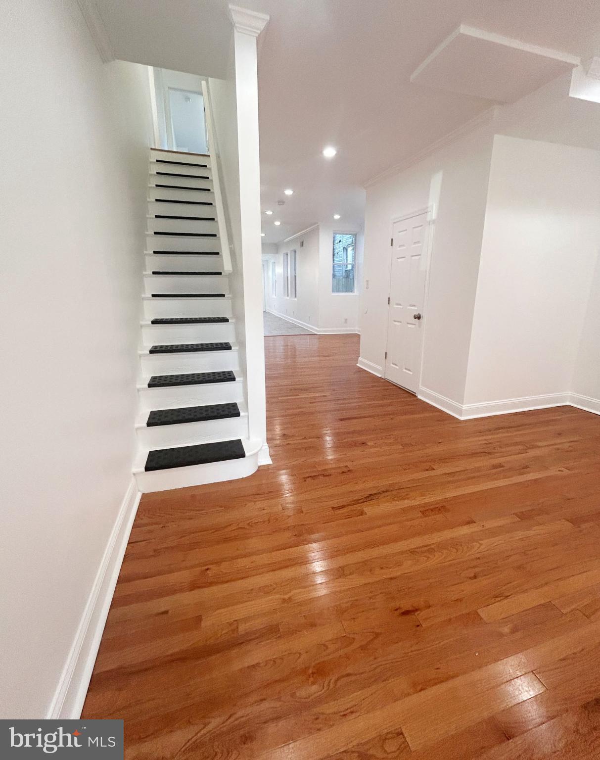 1241 Orthodox Street Philadelphia, PA 19124 - Photo 13 of 26 an empty room with wooden floor and white walls