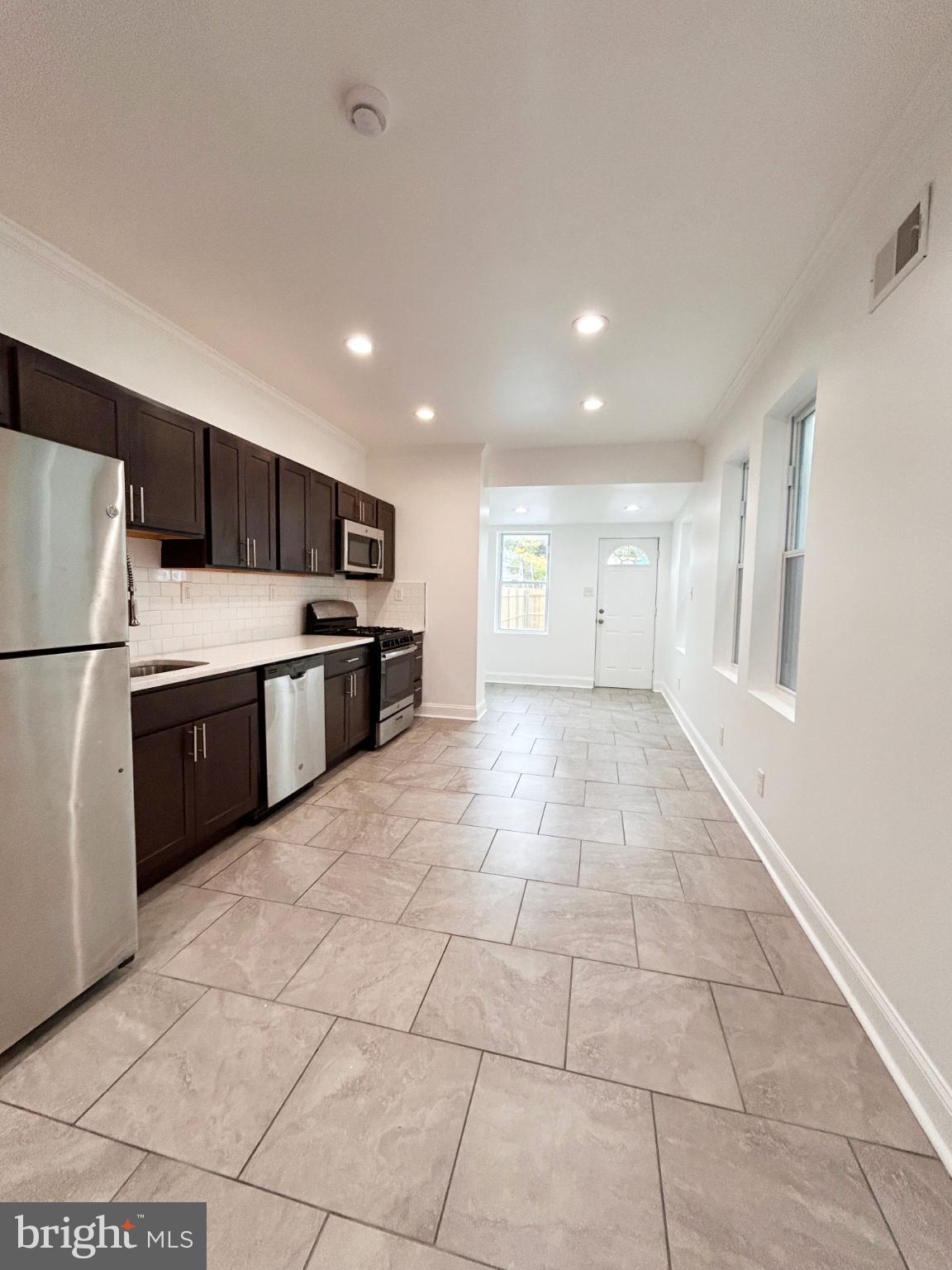 1241 Orthodox Street Philadelphia, PA 19124 - Photo 8 of 26 a open kitchen with cabinets and stainless steel appliances