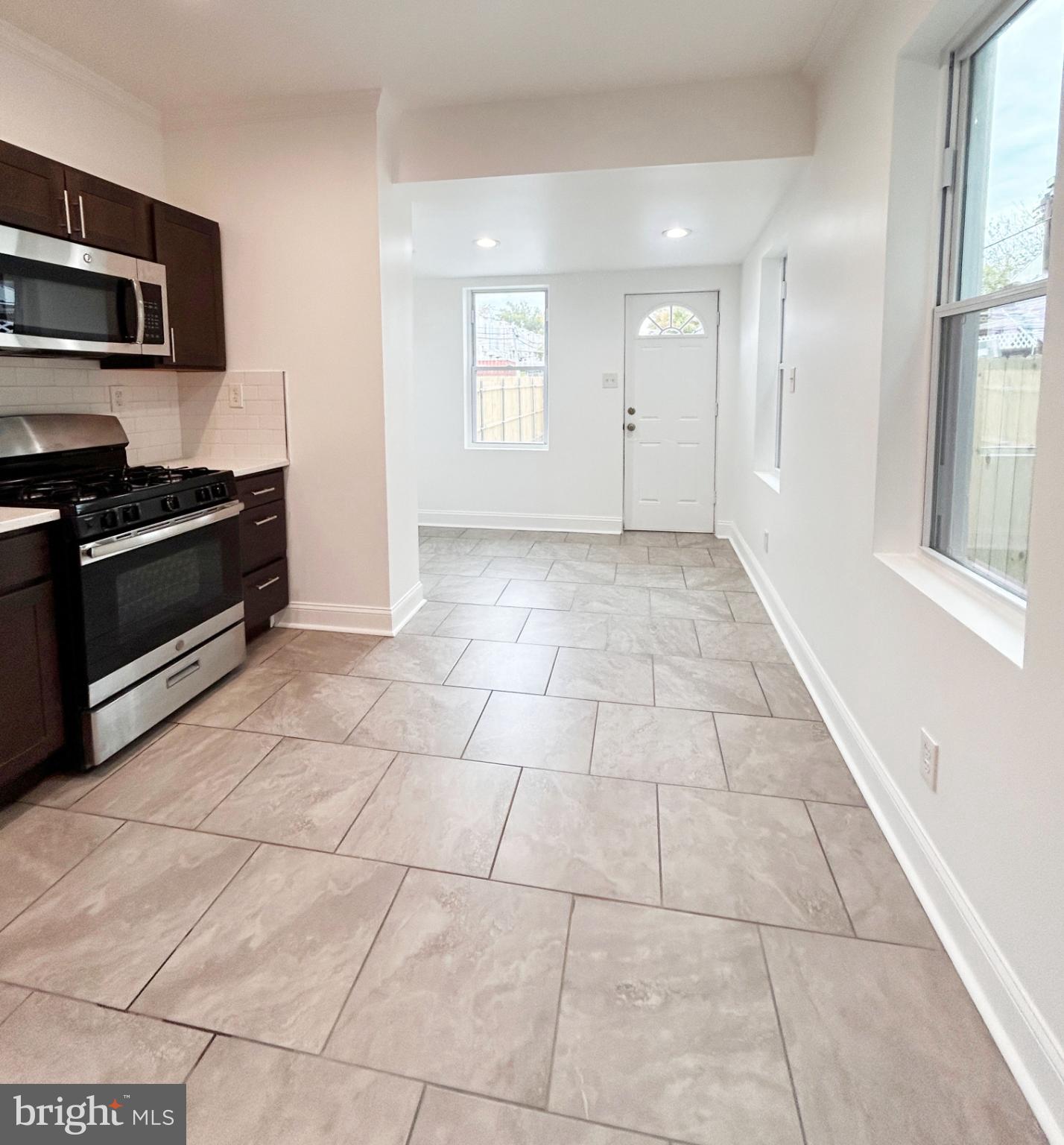 1241 Orthodox Street Philadelphia, PA 19124 - Photo 9 of 26 a view of a kitchen with an empty space and a window