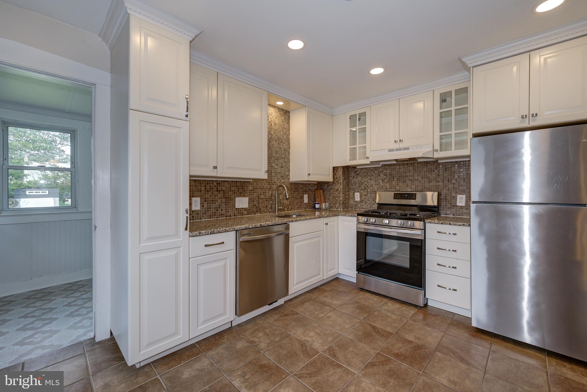 323 Cleveland Avenue Riverside, NJ 08075 - Photo 1 of 36 a kitchen with cabinets and stainless steel appliances