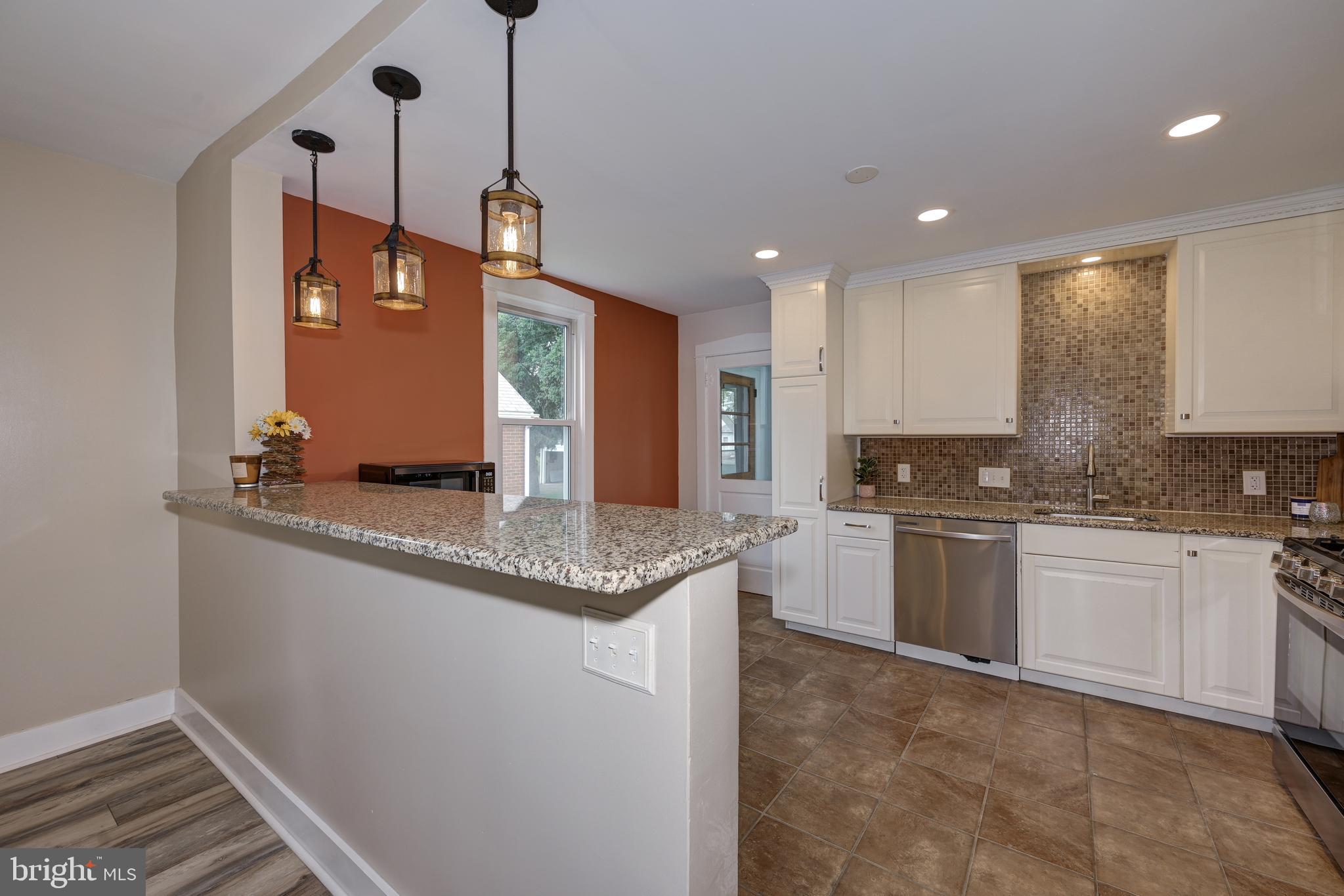 323 Cleveland Avenue Riverside, NJ 08075 - Photo 18 of 36 a kitchen with stainless steel appliances granite countertop a sink a stove and a refrigerator