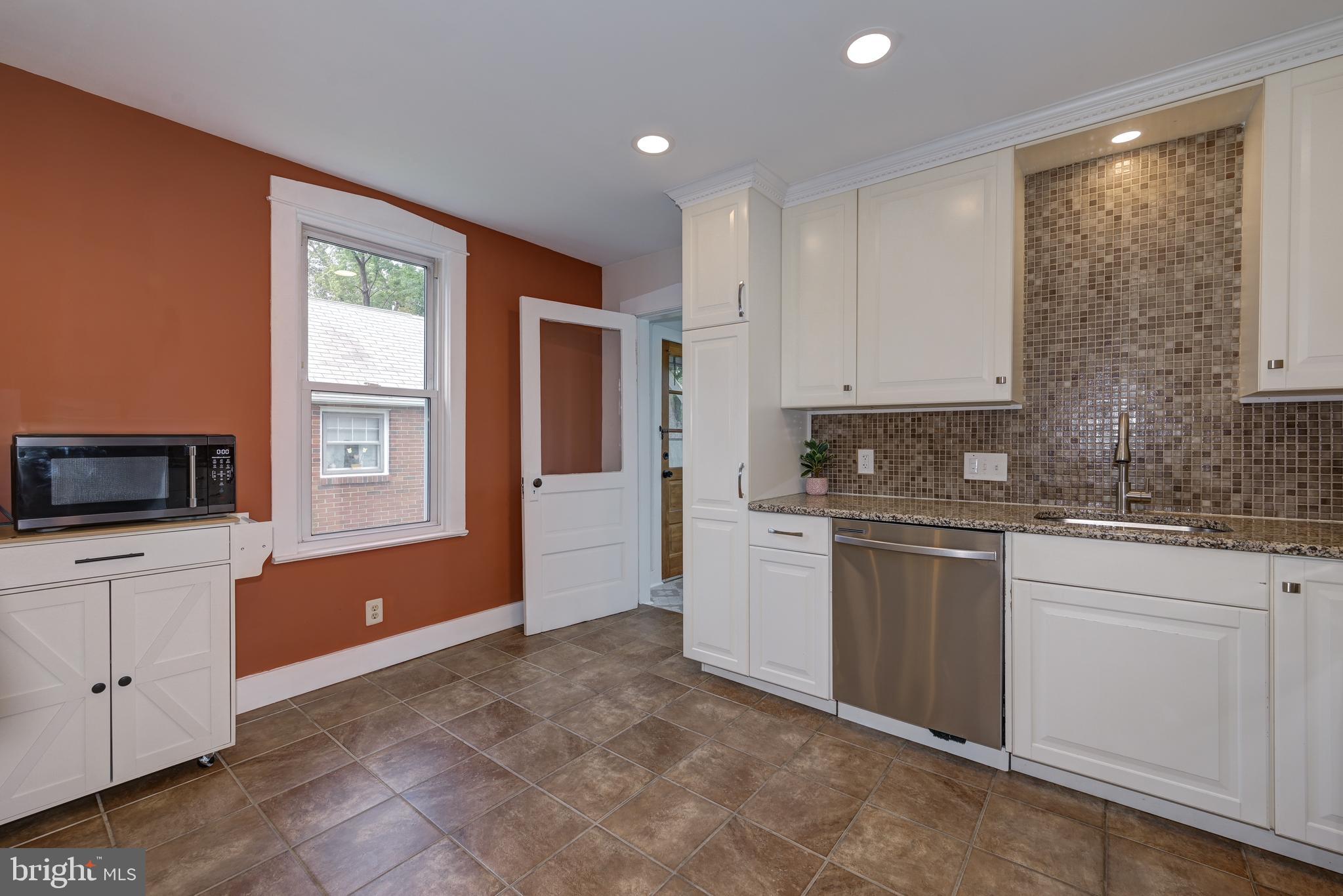 323 Cleveland Avenue Riverside, NJ 08075 - Photo 19 of 36 a kitchen with granite countertop a refrigerator and white cabinets