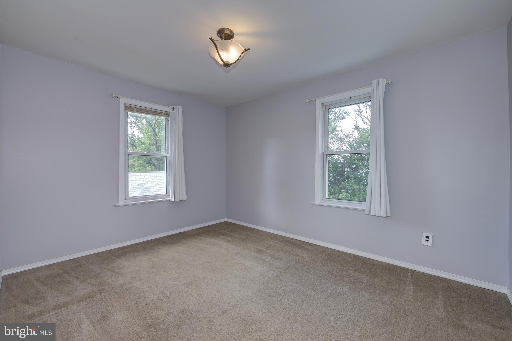 323 Cleveland Avenue Riverside, NJ 08075 - Photo 29 of 36 an empty room with windows and chandelier fan