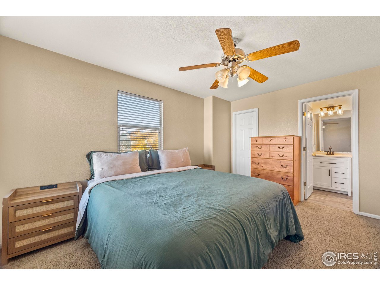 10688 Durango Place Longmont, CO 80504 - Photo 19 of 49 a bedroom with a bed and a chandelier