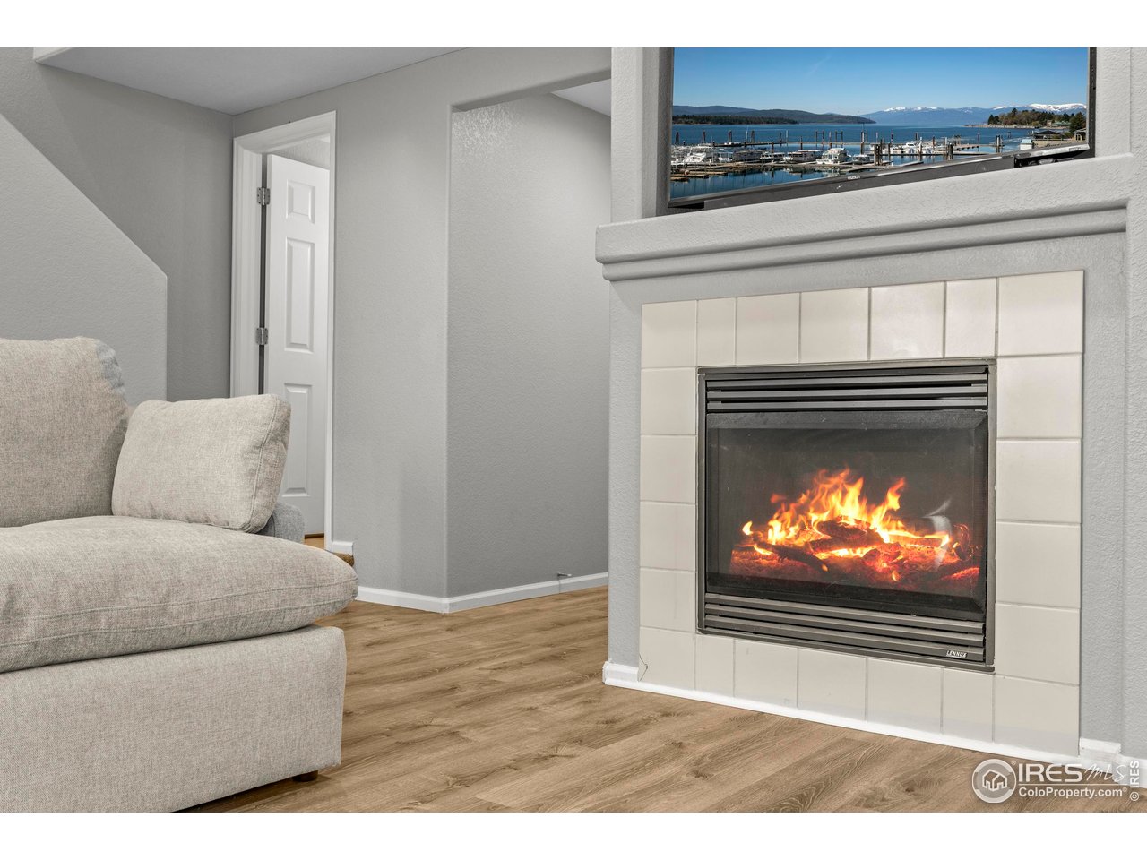 10688 Durango Place Longmont, CO 80504 - Photo 7 of 49 a living room with furniture a fireplace and a flat screen tv