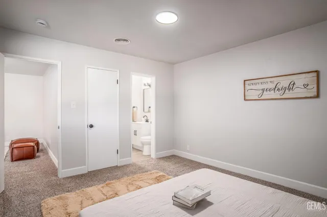 a bedroom with a bed and hallway