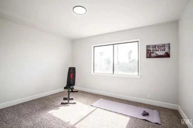 a room with gym equipment and windows