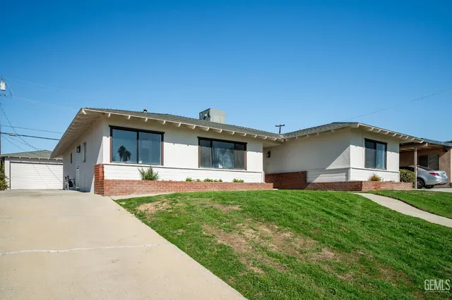 a front view of a house with a garden and deck