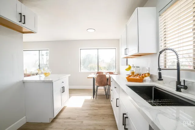 a kitchen that has a sink and cabinets