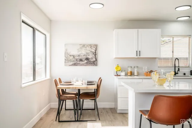 a view of a dining room with furniture and a window