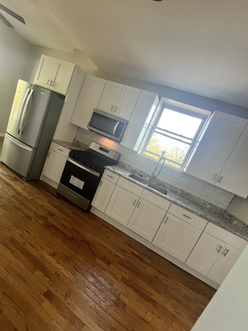 501 West 60th Place, Unit 3 Chicago, IL 60621 - Photo 6 of 12 a view of an empty room with wooden floor