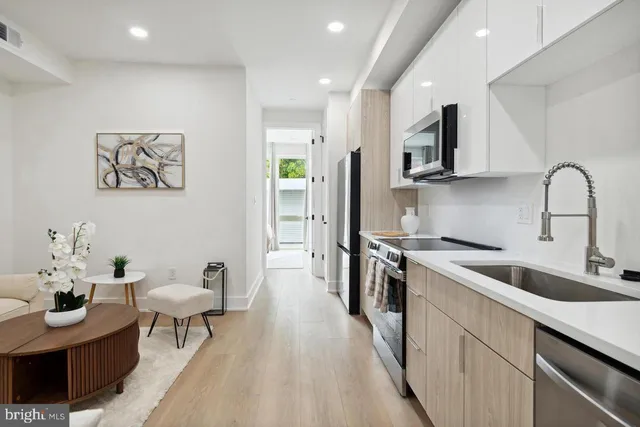 a kitchen with stainless steel appliances granite countertop a sink and a stove top oven