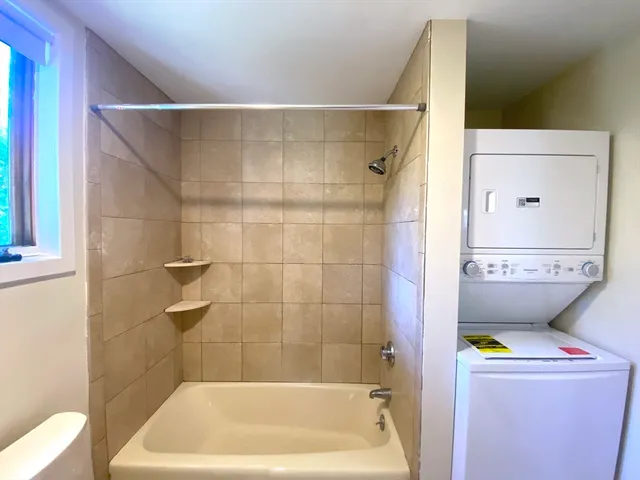 a bathroom with a bathtub and toilet