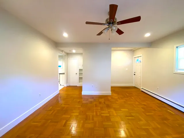 a view of a big room with a ceiling fan