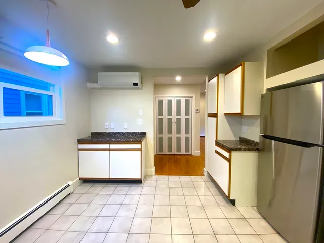 a kitchen with stainless steel appliances granite countertop a refrigerator a stove and a sink