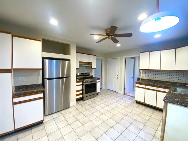 a kitchen with stainless steel appliances a refrigerator and a stove top oven
