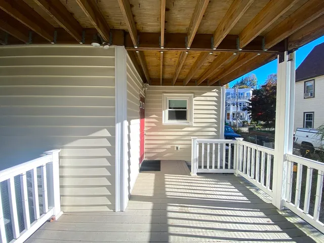 a view of a porch with wooden floor