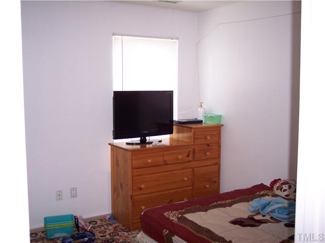 5519 Marthonna Way Raleigh, NC 27616 - Photo 10 of 10 a room with a dresser and a flat screen tv