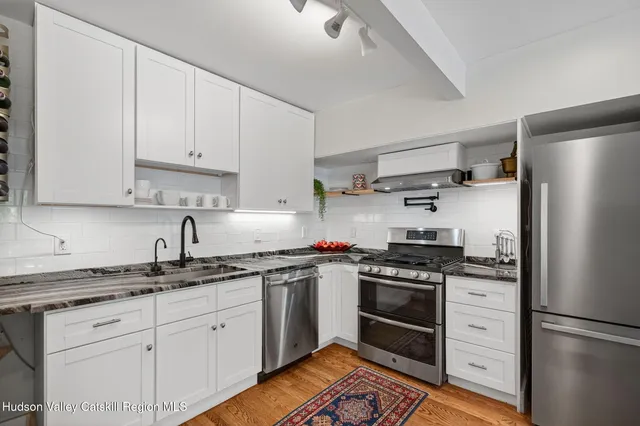 a stove top oven sitting inside of a kitchen